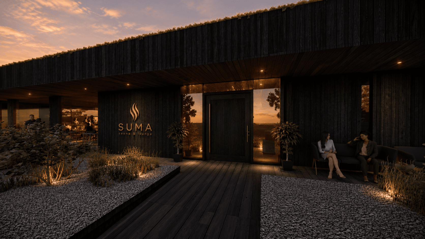 The charred timber entrance of SUMA glowing in the twilight